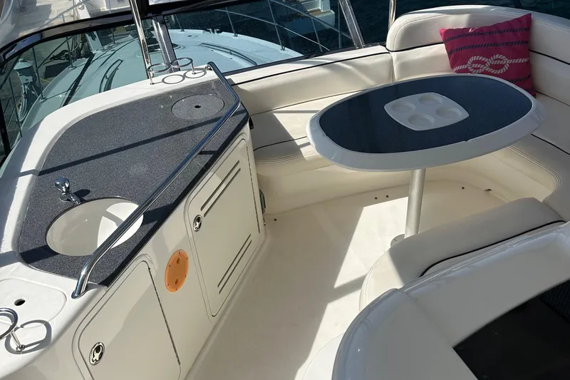Knot Available Yacht Photos Pics 2005 Sea Ray 500 Sedan Bridge interior with seating, table, and sink.