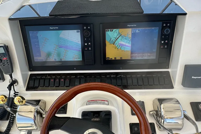 Knot Available Yacht Photos Pics Helm of 2005 Sea Ray 500 Sedan Bridge with Raymarine navigation displays and controls.