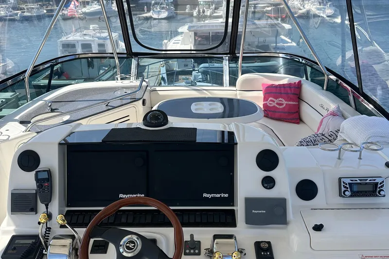 Knot Available Yacht Photos Pics 2005 Sea Ray 500 Sedan Bridge yacht cockpit with navigation equipment and seating area.