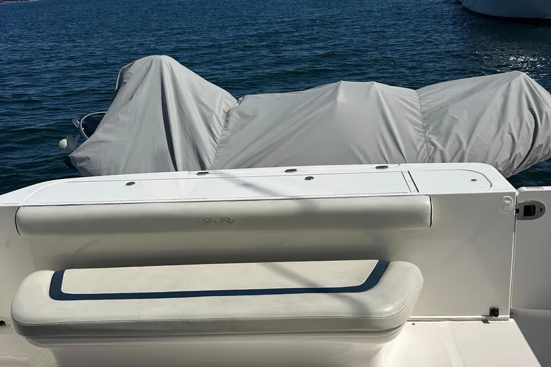 Knot Available Yacht Photos Pics 2005 Sea Ray 500 Sedan Bridge yacht with covered equipment on deck, docked on calm water.