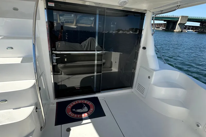 Knot Available Yacht Photos Pics 2005 Sea Ray 500 Sedan Bridge yacht with sliding glass door and Nantucket Boat Basin mat.