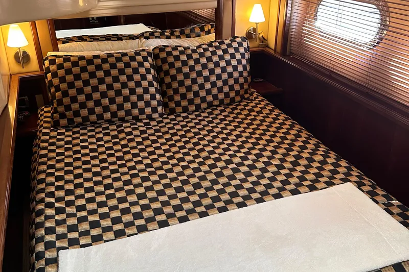 Knot Available Yacht Photos Pics Luxurious bedroom interior of 2005 Sea Ray 500 Sedan Bridge yacht with checkered bedding.