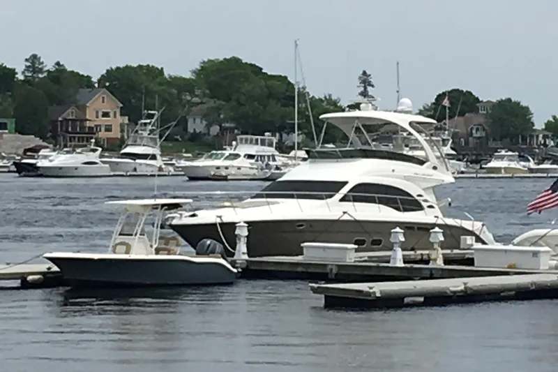 Knot Available Yacht Photos Pics 2005 Sea Ray 500 Sedan Bridge yacht docked in a scenic marina setting.