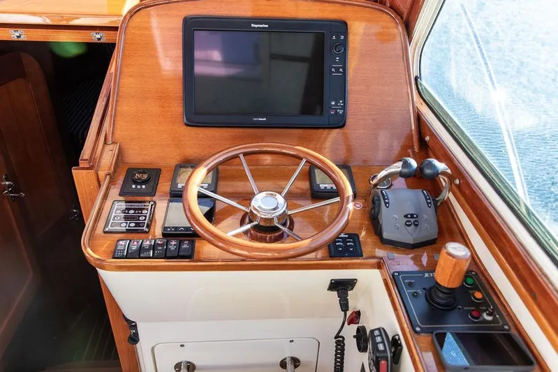 Checkout Time Yacht Photos Pics Hinckley Talaria 40 yacht helm with wooden steering wheel and navigation controls, 2007 model.