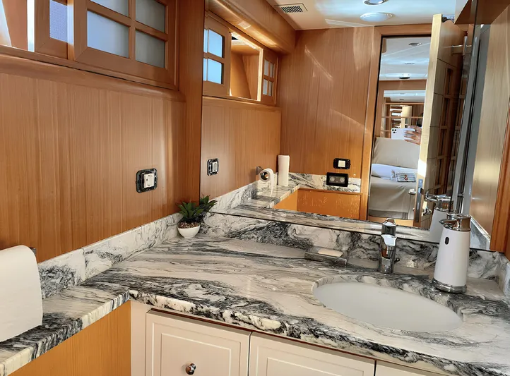  Yacht Photos Pics Luxurious yacht bathroom with marble countertop, wooden cabinetry, and modern fixtures, Custom 34 model, 2008.
