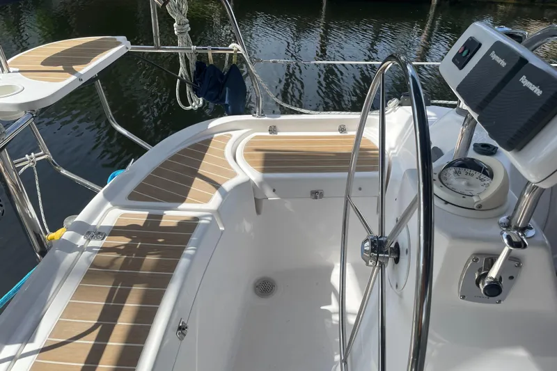 Sailing Diver Yacht Photos Pics 2010 Hunter 49 Aft Cockpit sailboat with steering wheel and teak seating.