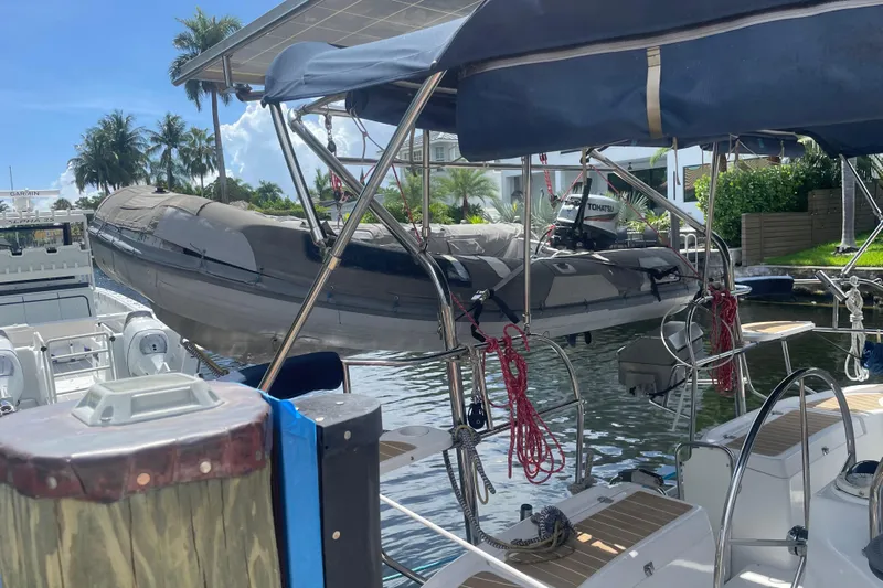 Sailing Diver Yacht Photos Pics Hunter 49 Aft Cockpit 2010 yacht with dinghy, docked in a sunny marina.