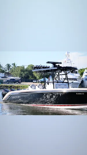  Yacht Photos Pics 2012 Donzi 38 ZF boat on calm water, sleek design, black hull, sunny day.
