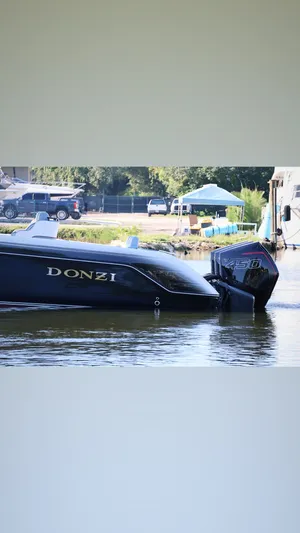  Yacht Photos Pics 2012 Donzi 38 ZF boat docked on calm water, featuring sleek design and powerful engine.