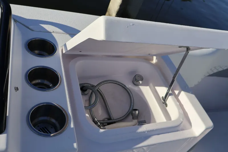  Yacht Photos Pics Open storage compartment on 2012 Donzi 38 ZF boat with cup holders and hose.