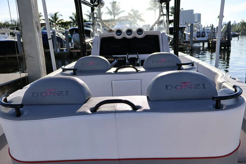  Yacht Photos Pics 2012 Donzi 38 ZF boat interior with branded seating at a marina.