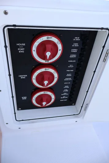  Yacht Photos Pics Control panel of a 2012 Donzi 38 ZF boat with red switches and labeled functions.