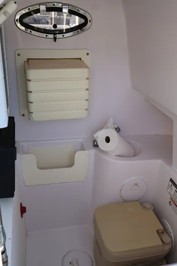  Yacht Photos Pics Interior of a 2012 Donzi 38 ZF boat, featuring a compact marine toilet.