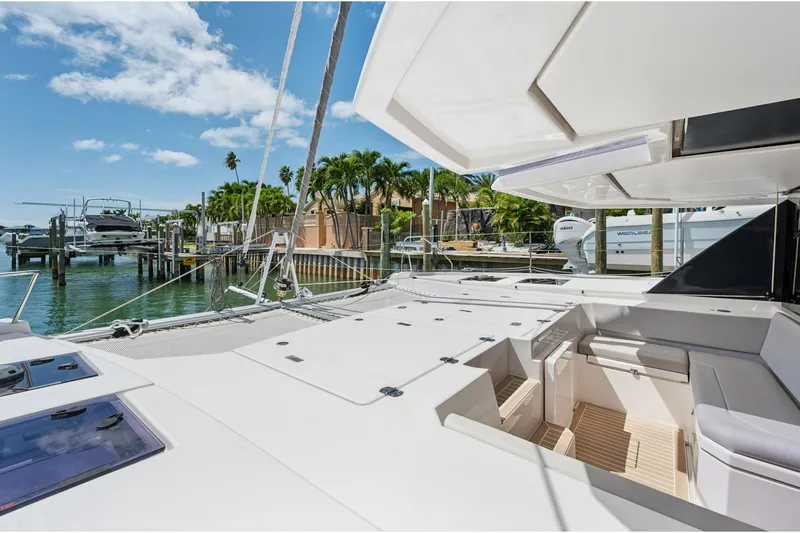 Always Wet Yacht Photos Pics 2021 Leopard 45 catamaran docked, featuring spacious deck and seating area under clear skies.