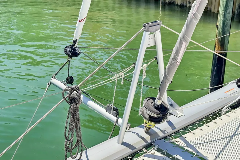 Always Wet Yacht Photos Pics Rope rigging on a 2021 Leopard 45 catamaran, docked in calm green water.