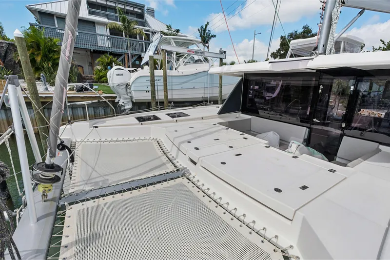 Always Wet Yacht Photos Pics 2021 Leopard 45 catamaran docked, showcasing spacious deck and modern design.