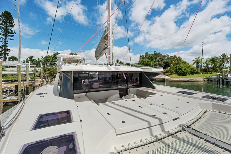 Always Wet Yacht Photos Pics 2021 Leopard 45 catamaran docked, showcasing sleek design and spacious deck under a clear sky.