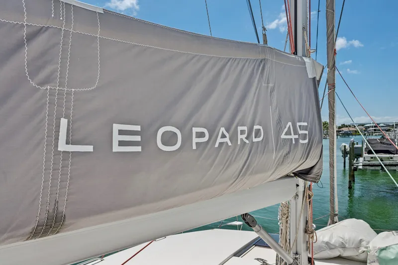 Always Wet Yacht Photos Pics 2021 Leopard 45 sailboat with branded cover docked at marina.