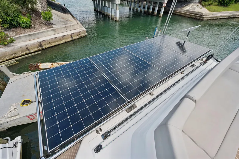 Always Wet Yacht Photos Pics Solar panels on a 2021 Leopard 45 catamaran docked near a bridge.