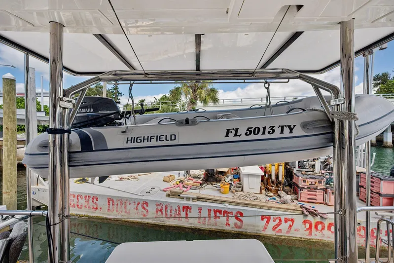 Always Wet Yacht Photos Pics 2021 Leopard 45 yacht with Highfield dinghy on davit, docked at marina.