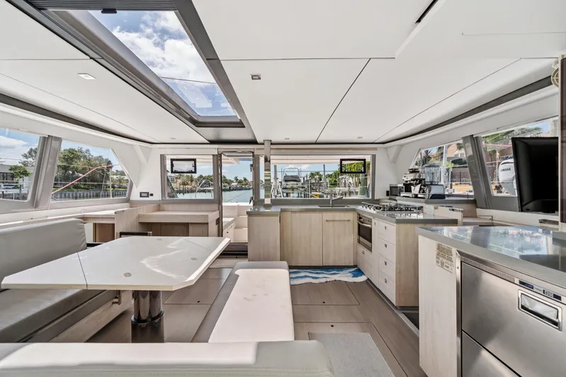 Always Wet Yacht Photos Pics Luxurious interior of 2021 Leopard 45 catamaran with modern kitchen and dining area.