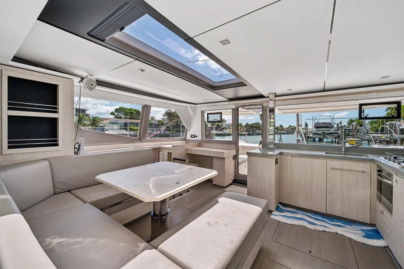 Always Wet Yacht Photos Pics Luxurious interior of 2021 Leopard 45 catamaran with modern kitchen and spacious seating area.