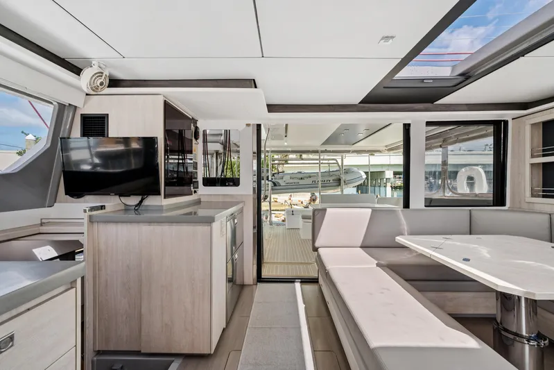 Always Wet Yacht Photos Pics Modern interior of 2021 Leopard 45 yacht with sleek design and spacious seating area.