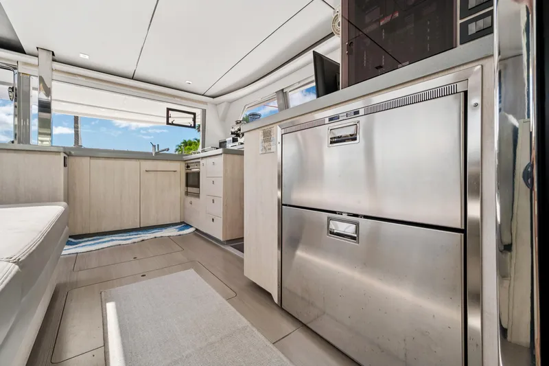Always Wet Yacht Photos Pics Modern kitchen interior of 2021 Leopard 45 yacht with stainless steel appliances.