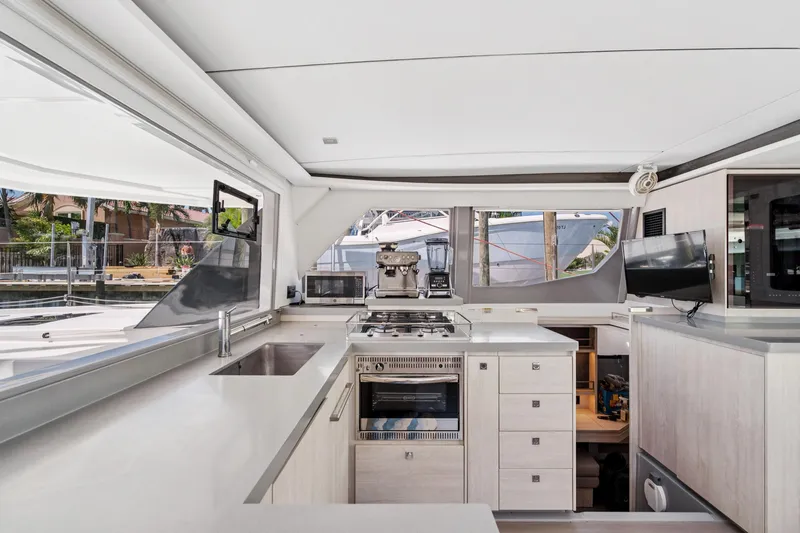 Always Wet Yacht Photos Pics Modern kitchen interior on 2021 Leopard 45 yacht, featuring sleek countertops and appliances.