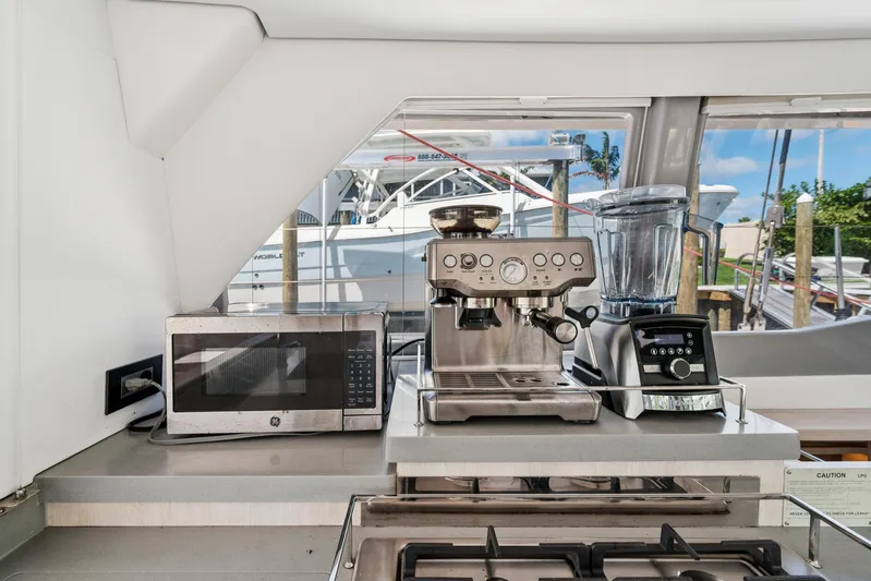 Always Wet Yacht Photos Pics Modern kitchen appliances on Leopard 45 yacht, featuring microwave, espresso machine, and blender.
