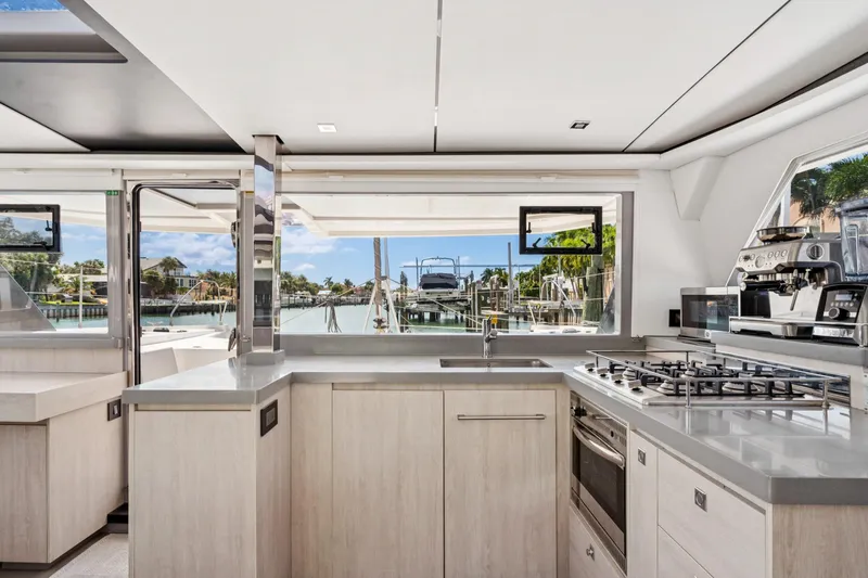 Always Wet Yacht Photos Pics Modern kitchen interior on 2021 Leopard 45 yacht, featuring sleek countertops and appliances.