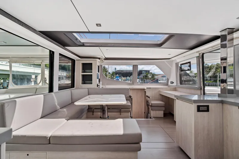 Always Wet Yacht Photos Pics Luxurious interior of 2021 Leopard 45 catamaran with modern seating and panoramic windows.