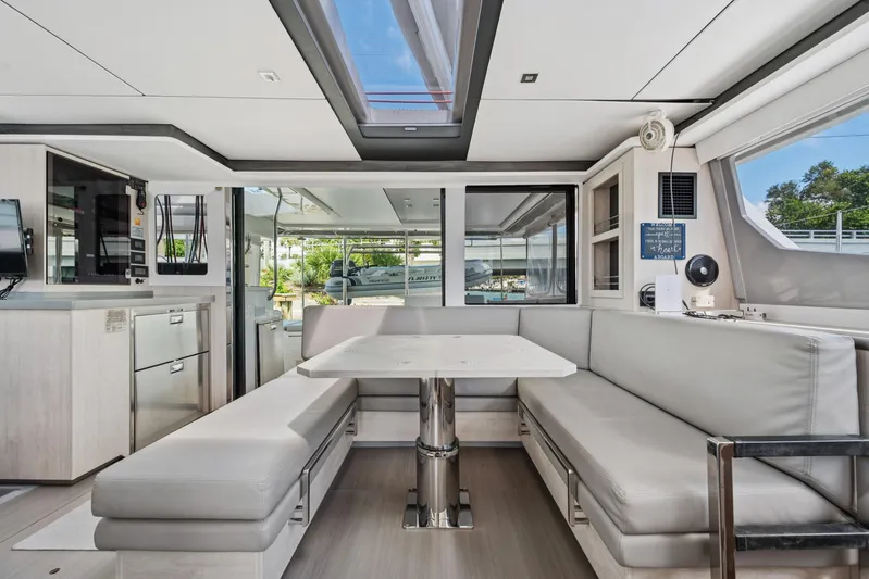 Always Wet Yacht Photos Pics Modern interior of 2021 Leopard 45 catamaran with sleek seating and dining area.