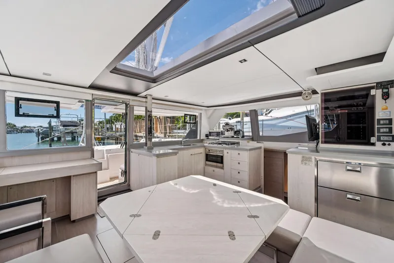 Always Wet Yacht Photos Pics Modern interior of 2021 Leopard 45 yacht with spacious kitchen and dining area.