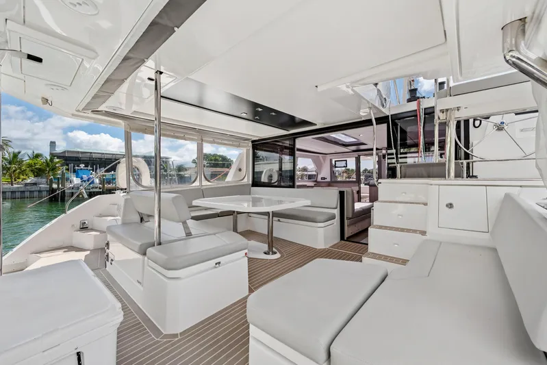 Always Wet Yacht Photos Pics Spacious interior of 2021 Leopard 45 catamaran with modern seating and dining area.