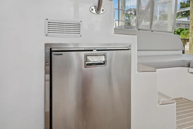 Always Wet Yacht Photos Pics Stainless steel fridge on 2021 Leopard 45 yacht, near seating area.