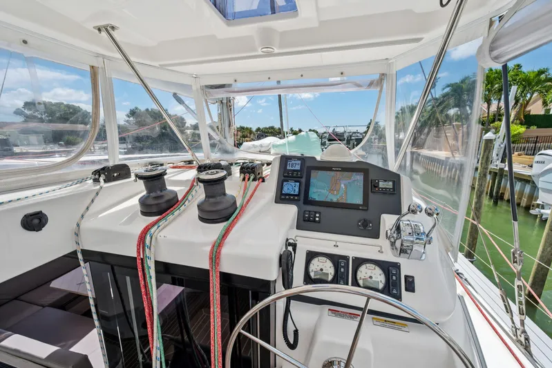 Always Wet Yacht Photos Pics Cockpit of 2021 Leopard 45 catamaran with navigation equipment and steering wheel.