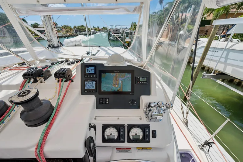 Always Wet Yacht Photos Pics Leopard 45 yacht helm with navigation system and controls, docked in a marina.