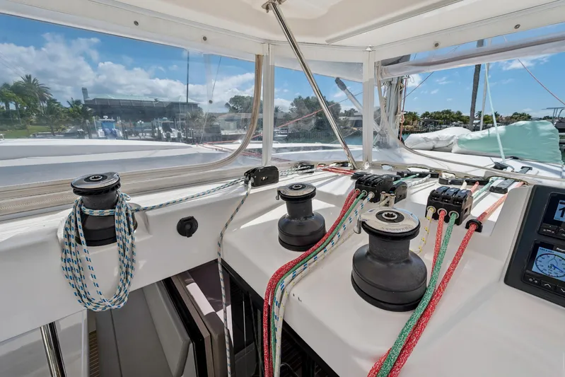 Always Wet Yacht Photos Pics 2021 Leopard 45 yacht deck with winches and colorful ropes under clear sky.