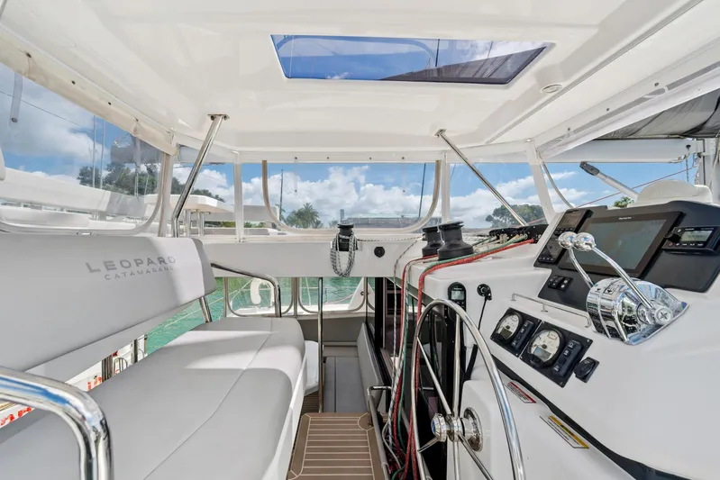 Always Wet Yacht Photos Pics Interior view of 2021 Leopard 45 catamaran cockpit with modern navigation equipment.
