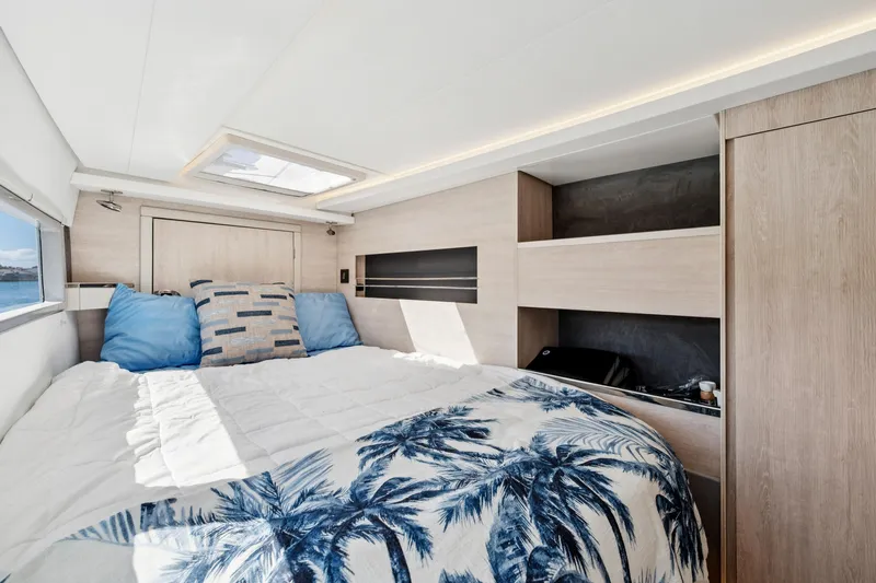 Always Wet Yacht Photos Pics Luxurious bedroom interior of 2021 Leopard 45 yacht with modern design and ocean view.