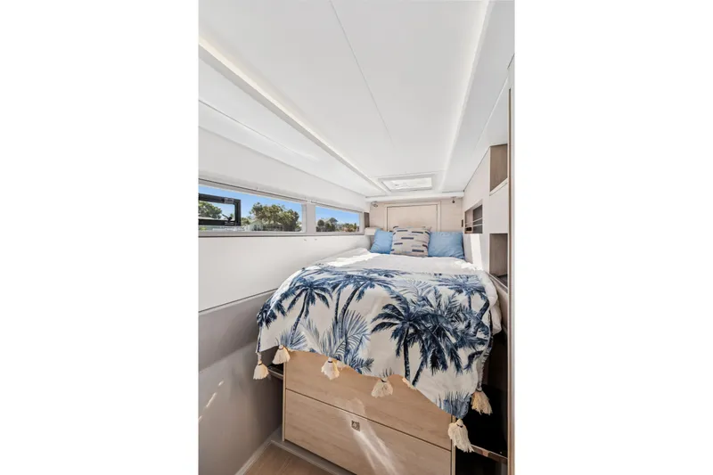Always Wet Yacht Photos Pics Luxurious bedroom interior of 2021 Leopard 45 yacht with tropical-themed bedding.