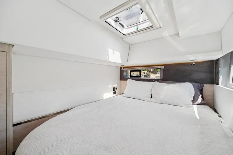 Always Wet Yacht Photos Pics Luxurious bedroom interior of 2021 Leopard 45 yacht with skylight and cozy bedding.