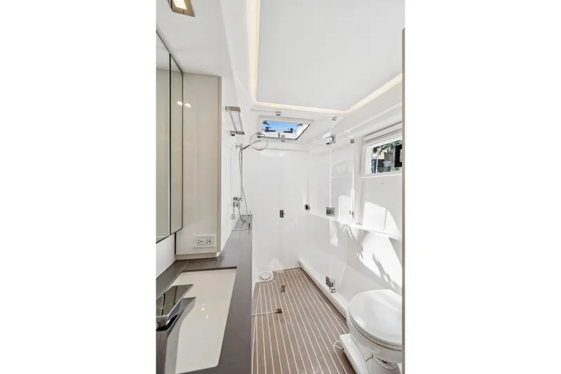 Always Wet Yacht Photos Pics Modern bathroom interior on 2021 Leopard 45 yacht, featuring sleek design and natural lighting.