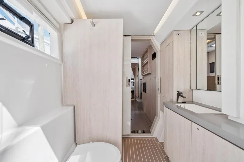 Always Wet Yacht Photos Pics Modern bathroom interior of 2021 Leopard 45 yacht, featuring sleek design and ample natural light.