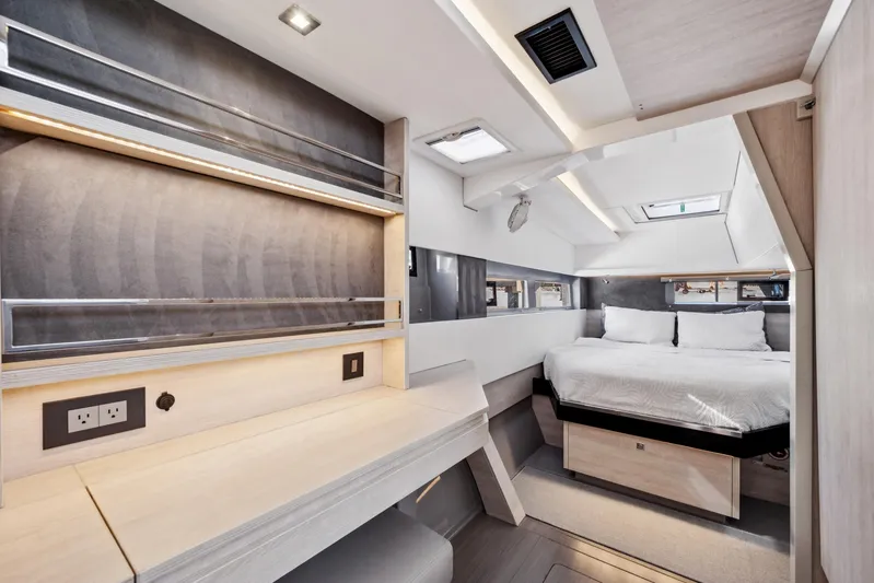 Always Wet Yacht Photos Pics Luxurious interior of 2021 Leopard 45 yacht with modern bedroom and workspace.