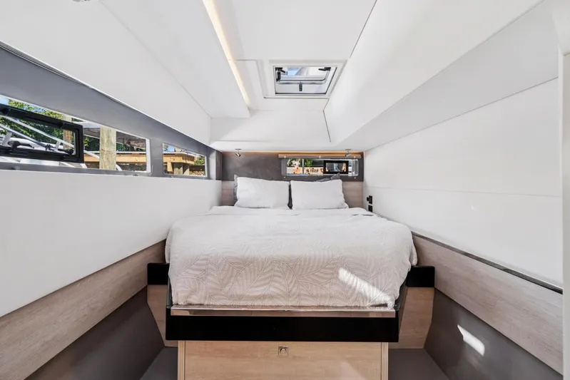 Always Wet Yacht Photos Pics Modern bedroom interior on 2021 Leopard 45 yacht, featuring a cozy bed and sleek design.
