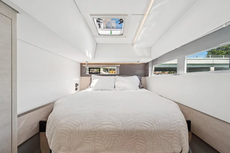 Always Wet Yacht Photos Pics Luxurious bedroom interior of 2021 Leopard 45 yacht with skylight and modern design.