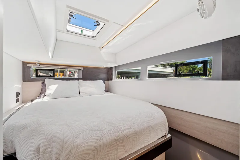 Always Wet Yacht Photos Pics Luxurious bedroom interior of 2021 Leopard 45 yacht with modern design and natural light.