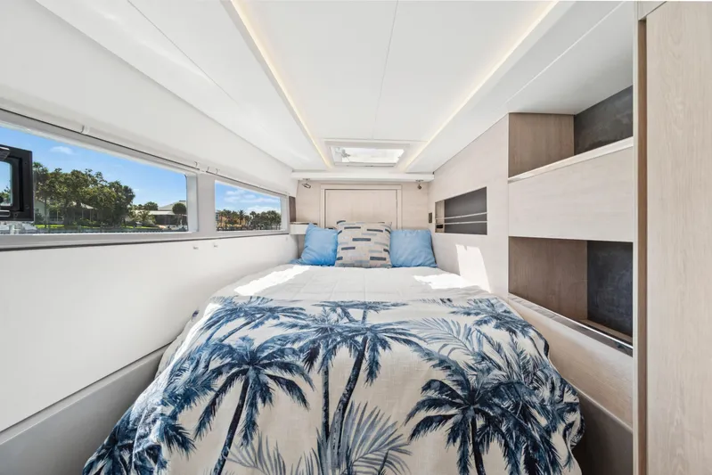 Always Wet Yacht Photos Pics Luxurious 2021 Leopard 45 yacht bedroom with palm-themed bedding and modern design.